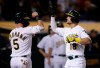 Oakland Athletics' Chad Pinder, right, celebrates with Chris Herrmann (5) after hitting a three-run home run off St. Louis Cardinals' Tyler Webb during the seventh inning of a baseball game Saturday, Aug. 3, 2019, in Oakland, Calif. (AP Photo/Ben Margot)