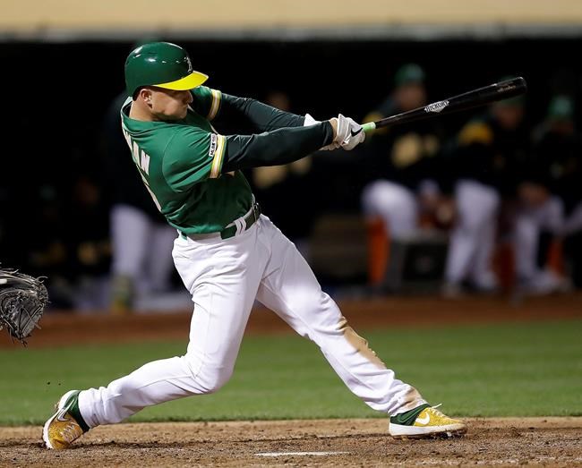 Oakland Athletics' Matt Chapman swings for a game-winning solo home run against the Cleveland Indians during the 12th inning of a baseball game Friday, May 10, 2019, in Oakland, Calif. (AP Photo/Ben Margot)