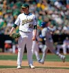 Oakland Athletics' Ryan Buchter (52) waits for Toronto Blue Jays' Justin Smoak to run the bases after giving up a two-run home run to Smoak in the sixth inning of a baseball game Saturday, April 20, 2019, in Oakland, Calif. (AP Photo/Ben Margot)
