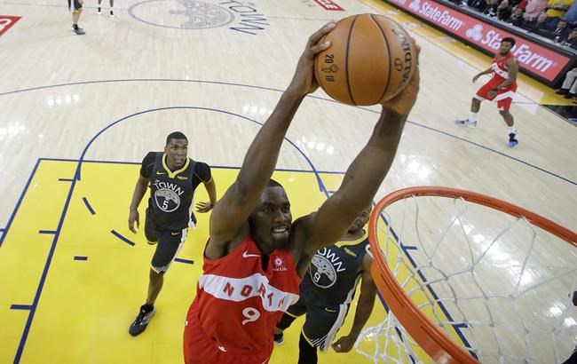 Toronto Raptors center Serge Ibaka (9) dunks against the Golden State Warriors during the second half of Game 4 of basketball's NBA Finals in Oakland, Calif., Friday, June 7, 2019. (AP Photo/Tony Avelar, Pool)