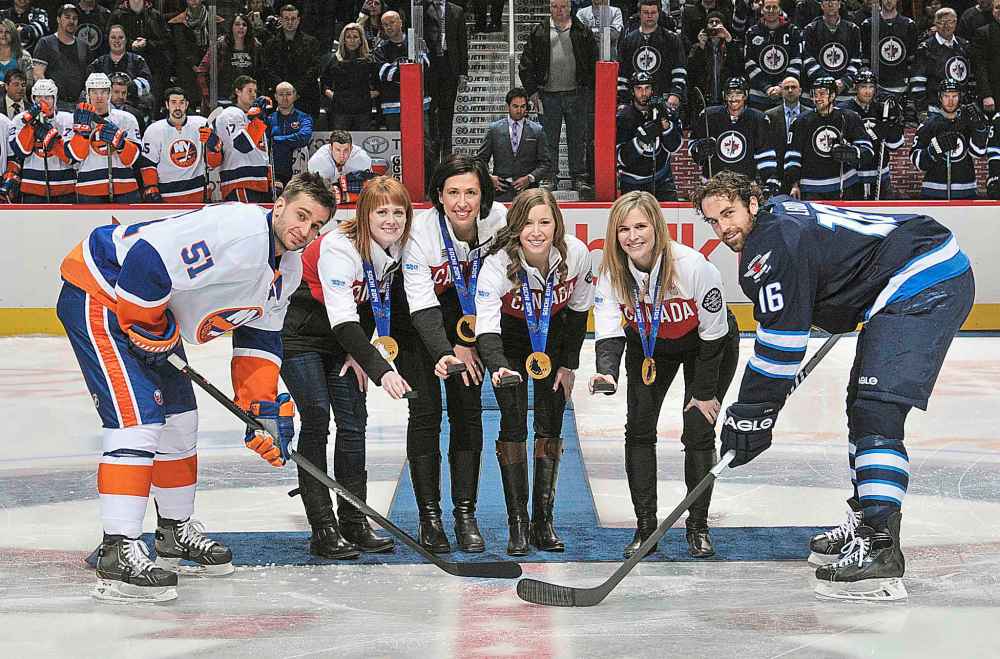 Courtesy of the Winnipeg Jets Hockey Club
Olympic gold medal-winning curling team (from left) Jennifer Jones, Dawn McEwen, Jill Officer and Kaitlyn Lawes take part in the ceremonial puck-drop before the Winnipeg Jets took on the New York Islanders in Winnipeg in 2014.