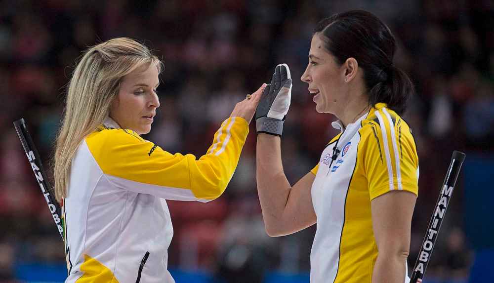 THE CANADIAN PRESS/Jonathan Hayward
Jones gives a high five to Officer during the Scotties Tournament of Hearts in Moose Jaw in 2015.