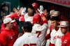 Cincinnati Reds' Eugenio Suarez celebrates with teammates after hitting a three-run home run during the second inning of the team's baseball game against the San Francisco Giants, Saturday, May 4, 2019, in Cincinnati. (AP Photo/Aaron Doster)