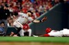 Cincinnati Reds' Yasiel Puig, right, steals third base ahead of the tag from San Francisco Giants' Evan Longoria in the sixth inning of a baseball game, Friday, May 3, 2019, in Cincinnati. (AP Photo/Aaron Doster)