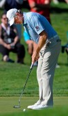 Retief Goosen, of South Africa, watches his birdie putt fall into the 18th hole to win the Bridgestone Senior Players Championship golf tournament at Firestone Country Club, Sunday, July 14, 2019, in Akron, Ohio. (Jeff Lange/Akron Beacon Journal via AP)