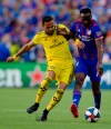 Columbus Crew SC midfielder Artur (8) attempts to get the ball from FC Cincinnati forward Roland Lamah (7) in the first half of an MLS soccer match Sunday, Aug. 25, 2019, in Cincinnati. (Albert Cesare/The Cincinnati Enquirer via AP)