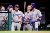National League manager Dave Roberts (30), of the Los Angeles Dodgers, talks with National League Kris Bryant (17), of the Chicago Cubs, during the fifth inning of the MLB baseball All-Star Game against the American League, Tuesday, July 9, 2019, in Cleveland. (AP Photo/John Minchillo)
