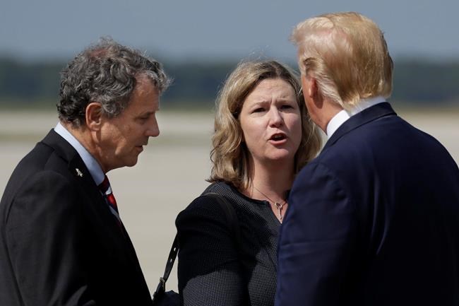 President Donald Trump is greeted by Dayton Mayor Nan Whaley and Sen. Sherrod Brown, D-Ohio, after arriving at Wright-Patterson Air Force Base to meet with people affected by the mass shooting in Dayton, Wednesday, Aug. 7, 2019, in Wright-Patterson Air Force Base, Ohio. (AP Photo/Evan Vucci)