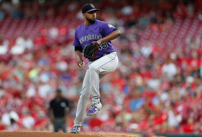 Colorado Rockies starting pitcher German Marquez throws against the Cincinnati Reds during the first inning of a baseball game, Friday, July 26, 2019, in Cincinnati. (AP Photo/Gary Landers)