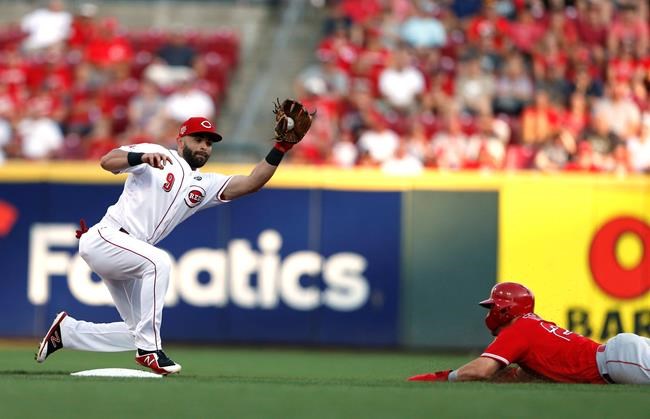 Cincinnati Reds second baseman Jose Peraza (9) takes the throw as Los Angeles Angels' Mike Trout, right, slides into second base with a steal during the first inning of a baseball game, Monday, Aug. 5, 2019, in Cincinnati. (AP Photo/Gary Landers)