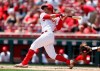 Cincinnati Reds' Jose Iglesias hits an RBI-single off Colorado Rockies starting pitcher Peter Lambert during the second inning of a baseball game, Sunday, July 28, 2019, in Cincinnati. (AP Photo/Gary Landers)