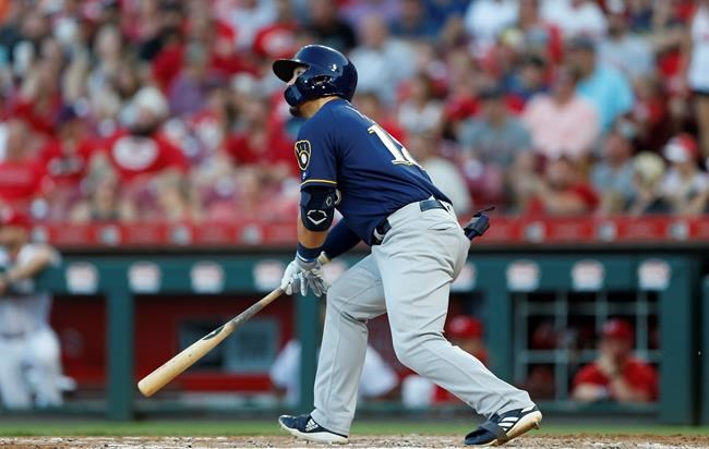 Milwaukee Brewers' Keston Hiura (18) watches the flight of a solo home run off Cincinnati Reds starting pitcher Tyler Mahle during the fifth inning of a baseball game, Monday, July 1, 2019, in Cincinnati. (AP Photo/Gary Landers)