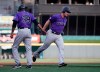 Colorado Rockies' Daniel Murphy, right, is congratulated on a three-run home run off Cincinnati Reds starting pitcher Luis Castillo by third base coach Stu Cole (39) during the first inning of a baseball game, Friday, July 26, 2019, in Cincinnati. (AP Photo/Gary Landers)