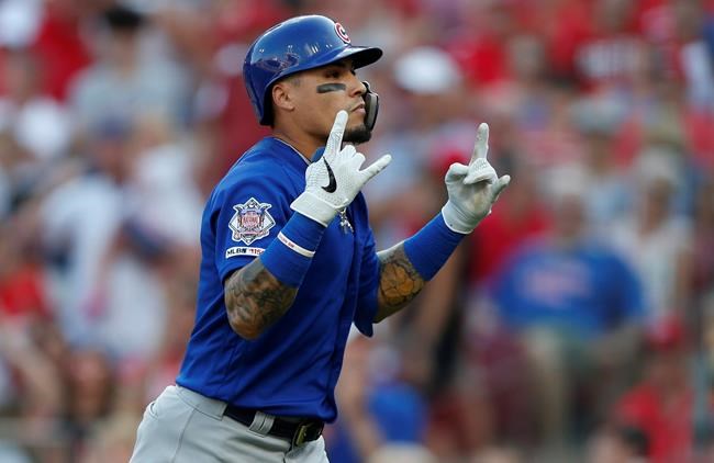 Chicago Cubs' Javier Baez reacts after hitting a grand slam off Cincinnati Reds relief pitcher Jared Hughes during the eighth inning of a baseball game, Saturday, June 29, 2019, in Cincinnati. (AP Photo/Gary Landers)