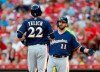 Milwaukee Brewers' Christian Yelich (22) is greeted at home plate by Mike Moustakas (11) following a solo home run off Cincinnati Reds starting pitcher Tanner Roark during the fourth inning of a baseball game, Tuesday, July 2, 2019, in Cincinnati. (AP Photo/Gary Landers)
