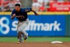 Milwaukee Brewers' Tyler Saladino (13) breaks for third base on a throwing error by Cincinnati Reds catcher Curt Casali after stealing second during the fifth inning of a baseball game, Wednesday, July 3, 2019, in Cincinnati. (AP Photo/Gary Landers)