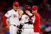 Cincinnati Reds starting pitcher Luis Castillo (58) reacts after being pulled by manager David Bell, right, during the fifth inning of a baseball game against the St. Louis Cardinals, Friday, Aug. 16, 2019, in Cincinnati. Reds catcher Tucker Barnhart, center, looks on. (AP Photo/Gary Landers)