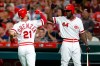 Cincinnati Reds' Michael Lorenzen (21) is congratulated by Aristides Aquino after scoring during the seventh inning of the team's baseball game against the St. Louis Cardinals, Saturday, Aug. 17, 2019, in Cincinnati. (AP Photo/Gary Landers)