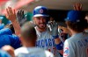 Chicago Cubs' Kris Bryant, center, celebrates a three-run home run off Cincinnati Reds relief pitcher Michael Lorenzen during the seventh inning of a baseball game, Sunday, Aug. 11, 2019, in Cincinnati. (AP Photo/Gary Landers)