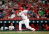 Cincinnati Reds' Tucker Barnhart follows through on a solo home run off Los Angeles Angels relief pitcher Justin Anderson during the sixth inning of a baseball game Tuesday, Aug. 6, 2019, in Cincinnati. (AP Photo/Gary Landers)
