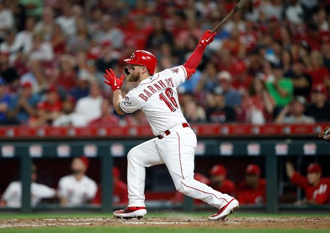 Cincinnati Reds' Tucker Barnhart follows through on a solo home run off Los Angeles Angels relief pitcher Justin Anderson during the sixth inning of a baseball game Tuesday, Aug. 6, 2019, in Cincinnati. (AP Photo/Gary Landers)