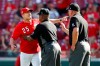 Cincinnati Reds manager David Bell (25) is restrained by umpire Laz Diaz, center, after being ejected by Jeff Nelson, right, following an argument over Reds' Eugenio Suarez being hit by a pitch by Pirates' Clay Holmes during the eighth inning of a baseball game against the Pittsburgh Pirates, Wednesday, May 29, 2019, in Cincinnati. The Pirates won 7-2. (AP Photo/Gary Landers)