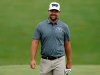 Ryan Moore smiles at his caddie on the 18th hole during the first round of the Memorial golf tournament Thursday, May 30, 2019, in Dublin, Ohio. (AP Photo/Jay LaPrete)