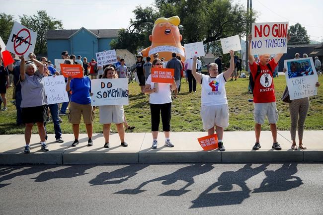 People gather to protest the arrival of President Donald Trump outside Miami Valley Hospital after a mass shooting that occurred in the Oregon District early Sunday morning, Wednesday, Aug. 7, 2019, in Dayton, Ohio. (AP Photo/John Minchillo)