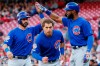 Chicago Cubs' Albert Almora Jr., center, and Daniel Descalso, left, celebrate with Jason Heyward, right, after scoring on a two-run double by Kyle Hendricks off Cincinnati Reds starting pitcher Tanner Roark during the second inning of a baseball game Tuesday, May 14, 2019, in Cincinnati. (AP Photo/John Minchillo)