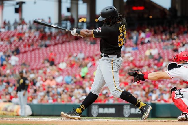 Pittsburgh Pirates' Josh Bell hits a two-run double off Cincinnati Reds starting pitcher Tanner Roark in the first inning of a baseball game, Tuesday, July 30, 2019, in Cincinnati. (AP Photo/John Minchillo)
