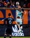 Real Salt Lake forward Sam Johnson, center, and FC Cincinnati midfielder Frankie Amaya, rear, vie for a head ball during the first half of an MLS soccer match Friday, April 19, 2019, in Cincinnati. (AP Photo/John Minchillo)