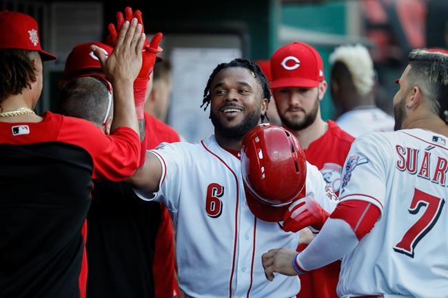 Cincinnati Reds' Phillip Ervin celebrates in the dugout after hitting a solo home run off Chicago Cubs relief pitcher Mike Montgomery during the second inning of a baseball game Friday, June 28, 2019, in Cincinnati. (AP Photo/John Minchillo)