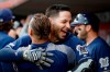 Milwaukee Brewers' Ryan Braun, center, celebrates in the dugout after hitting a grand slam off Cincinnati Reds starting pitcher Tyler Mahle during the first inning of a baseball game Wednesday, Sept. 25, 2019, in Cincinnati. (AP Photo/John Minchillo)