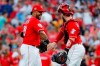 Cincinnati Reds second baseman Christian Colon (29) celebrates with catcher Tucker Barnhart, right, after closing the ninth inning of a baseball game against the New York Mets, Saturday, Sept. 21, 2019, in Cincinnati. (AP Photo/John Minchillo)