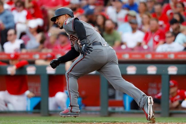 Arizona Diamondbacks' Eduardo Escobar hits a single off Cincinnati Reds starting pitcher Luis Castillo in the eighth inning of a baseball game, Saturday, Sept. 7, 2019, in Cincinnati. (AP Photo/John Minchillo)