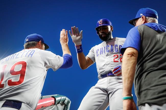 Chicago Cubs' Jason Heyward, center, celebrates at the dugout steps after hitting a two-run home run off Cincinnati Reds starting pitcher Sonny Gray during the seventh inning of a baseball game Friday, June 28, 2019, in Cincinnati. (AP Photo/John Minchillo)