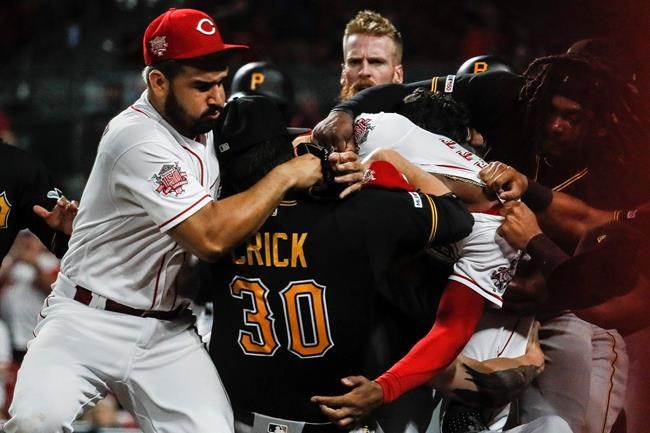 Pittsburgh Pirates' Kyle Crick (30) and Cincinnati Reds' Eugenio Suarez, left, and Amir Garrett, center right, brawl during the ninth inning of a baseball game Tuesday, July 30, 2019, in Cincinnati. (AP Photo/John Minchillo)