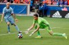 Sporting Kansas City goalkeeper Adrian Zendejas, right, makes a save in the second half of an MLS soccer match against FC Cincinnati, Sunday, April 7, 2019, in Cincinnati. (AP Photo/John Minchillo)