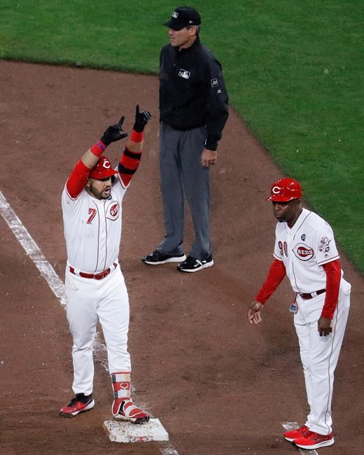 Cincinnati Reds' Eugenio Suarez (7) celebrates after hitting an RBI single off Chicago Cubs starting pitcher Jose Quintana during the fifth inning of a baseball game Thursday, May 16, 2019, in Cincinnati. (AP Photo/John Minchillo)