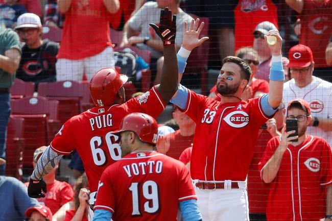 Cincinnati Reds' Yasiel Puig (66) celebrates with Jesse Winker (33) after hitting a two-run home run off Texas Rangers relief pitcher Peter Fairbanks in the fourth inning of a baseball game, Sunday, June 16, 2019, in Cincinnati. (AP Photo/John Minchillo)