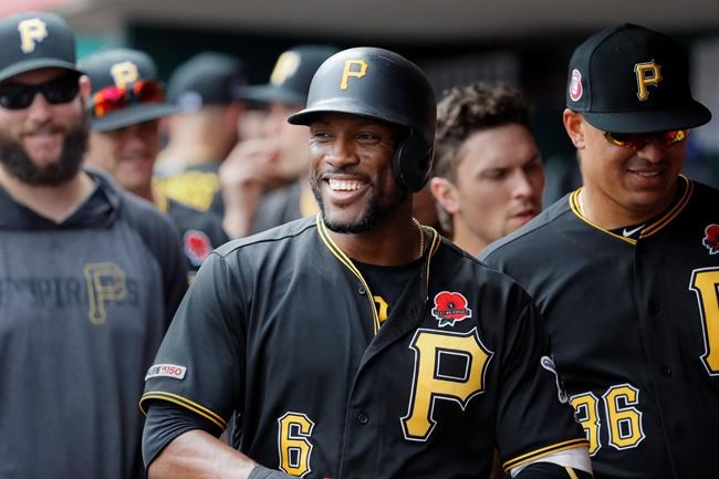 Pittsburgh Pirates' Starling Marte (6) celebrates in the dugout after hitting a two-run home run off Cincinnati Reds relief pitcher David Hernandez in the eighth inning during the first baseball game of a doubleheader, Monday, May 27, 2019, in Columbus. (AP Photo/John Minchillo)