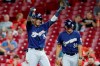 Milwaukee Brewers' Orlando Arcia reacts after reaching on a bunt single off Cincinnati Reds relief pitcher Kevin Gausman during the ninth inning of a baseball game, Tuesday, Sept. 24, 2019, in Cincinnati. (AP Photo/John Minchillo)