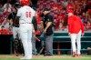 Cincinnati Reds manager David Bell, right, yells at umpire Larry Vanover, center, after being ejected during the ninth inning of a baseball game against the Pittsburgh Pirates, Tuesday, July 30, 2019, in Cincinnati. (AP Photo/John Minchillo)