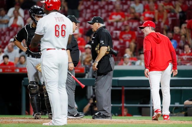 Cincinnati Reds manager David Bell, right, yells at umpire Larry Vanover, center, after being ejected during the ninth inning of a baseball game against the Pittsburgh Pirates, Tuesday, July 30, 2019, in Cincinnati. (AP Photo/John Minchillo)