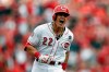 Cincinnati Reds' Derek Dietrich reacts as he runs the bases on his three-run home run off Pittsburgh Pirates relief pitcher Richard Rodriguez in the seventh inning of a baseball game, Thursday, March 28, 2019, in Cincinnati. (AP Photo/Gary Landers)