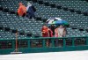 Die-hard Cleveland Indians fans hang out at Progressive Field after a baseball game against the Texas Rangers was called due to rain in Cleveland, Tuesday, Aug. 6, 2019. (AP Photo/Phil Long)