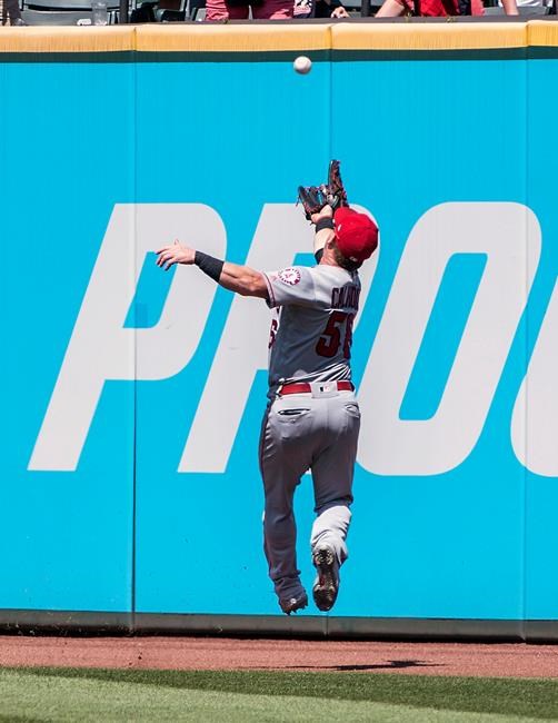 Los Angeles Angels' Kole Calhoun misses a fly ball by Cleveland Indians' Jordan Luplow during the fourth inning of a baseball game in Cleveland, Sunday, Aug. 4, 2019. (AP Photo/Phil Long)