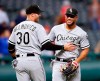 Chicago White Sox's Yoan Moncada (10) and Nicky Delmonico (30) celebrate a victory over the Cleveland Indians in a baseball game, Monday, May 6, 2019, in Cleveland. (AP Photo/Ron Schwane)