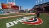 Mathew Gudin paints the opening day signage on the field before the Cleveland Indians play the Chicago White Sox in a baseball game, Monday, April 1, 2019, in Cleveland. (AP Photo/Tony Dejak)