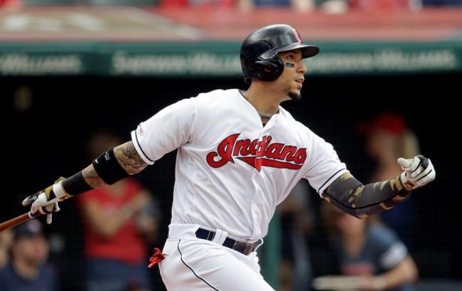 Cleveland Indians' Carlos Gonzalez watches his ball after hitting a sacrifice fly off Baltimore Orioles starting pitcher Yefry Ramirez in the first inning of a baseball game, Sunday, May 19, 2019, in Cleveland. Jason Kipnis scored on the play. (AP Photo/Tony Dejak)